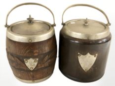 Two oak and EPNS mounted biscuit barrels with swing handles, overall height 24 cm.