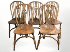 A set of five elm wheelback dining chairs with crinoline understretchers.