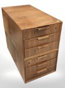 A pair of 20th century teak three drawer chests,
