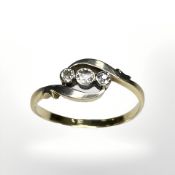 A diamond three stone crossover ring, size N½ CONDITION REPORT: Marks rubbed. 1.