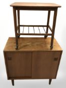 A 20th century Danish teak double sliding door cabinet, width 75 cm, and a small two tier trolley.