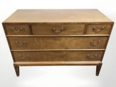A 20th continental century teak five drawer low chest,