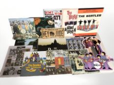 The Beatles - A quantity of reproduction enameled tin signs, largest 41 cm wide.