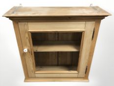 A glazed pine single door wall cabinet, width 77 cm.