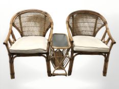 A pair of wicker chairs and a magazine table