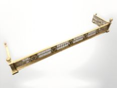 A late Victorian pierced brass fender,