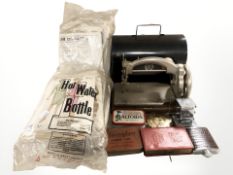 An Ideal miniature sewing machine, a quantity of knitting patterns, tins, small desk calendar,