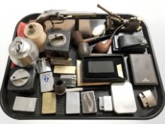 A group of pipes, pocket and table lighters.