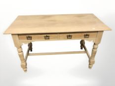 An early 20th century pine side table fitted two drawers,