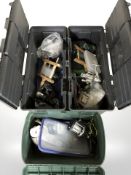 Three plastic fishing boxes containing reels and related equipment