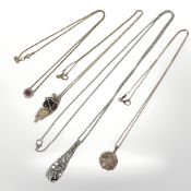 Four Sterling silver necklaces each with decorative pendants