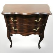 A reproduction two drawer serpentine front chest,