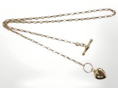 A 9ct yellow gold chain with T-bar suspended with a heart shaped charm,