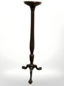 A mahogany torchere on claw and ball feet, height 143 cm.