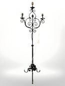 A wrought metal standard lamp, height 160 cm.