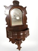 A late Victorian mahogany wall mirror, length 67 cm.