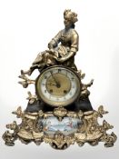 A gilt metal figural mantel clock with inset porcelain panel and enamel dial, height 39 cm.