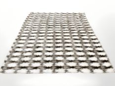 A synthetic fur rug, 210 cm x 240 cm.