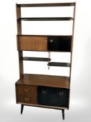 A 20th century G Plan teak and ebonised open bookcase/room divider designed by E.