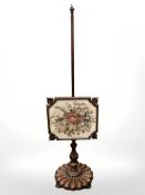 An early Victorian mahogany tapestry pole screen.