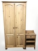 A modern pine double door wardrobe and a bedside cabinet