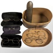 A group of antique spectacles in cases.