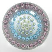 A 20th century Baccarat glass paperweight with four concentric circles of canes, diameter 6cm.