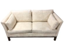 A late 20th century Danish wooden framed two seater settee, in cream upholstery,