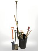 A plastic bucket of garden tools