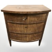 A 20th century continental walnut bow front three drawer chest,