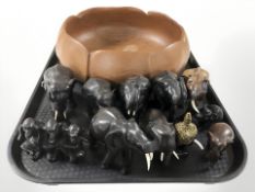 A wooden fruit bowl. a group of resin elephant ornaments and Thai bust of Buddha.