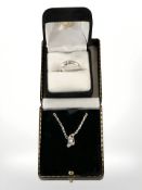 A silver necklace with spinning crystal pendant,