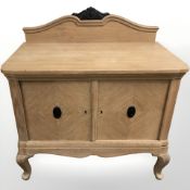 An early 20th century oak side cabinet on cabriole feet,