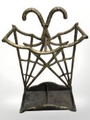 A brass umbrella stand with drip tray stamped 'The Greenhouse, Paris, France', height 66 cm.