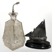 A cut and etched glass silver topped perfume bottle, height 19.