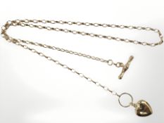 A 9ct yellow gold chain with T-bar suspended with a heart-shaped charm,