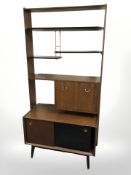 A 20th century G Plan teak and ebonised open bookcase/room divider designed by E.
