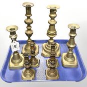 Four pairs of Victorian brass candlesticks.