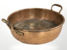 A 19th century copper twin handled cooking pan, overall width 40 cm.