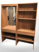 A 20th century teak two section open bookcase with mirrored back, overall 128 cm wide.