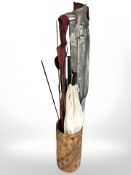 A wicker basket containing assorted fishing rods.