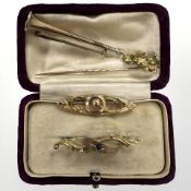 Three various gold brooches and a hat pin CONDITION REPORT: 7.3g gross.