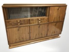 A 20th century continental walnut sideboard, fitted cupboards and drawers,