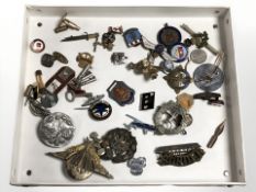 A group of military and other badges, decorations, lapel pins, several antique keys, school medals,