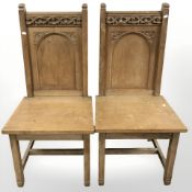 A pair of oak church chairs.