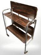A chrome and rosewood effect folding trolley.