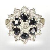 A 9ct yellow gold cluster ring set with diamonds and sapphires, size N.