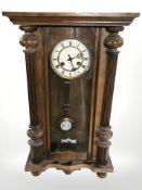 A Junghans walnut wall clock with pendulum and key, length 73 cm.
