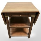 A mahogany brass mounted drop leaf bedside stand,