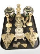 A group of brass candlesticks, trivet stands,